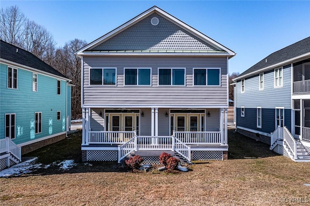 view of front of house featuring a porch, a standing seam roof, and a front lawn