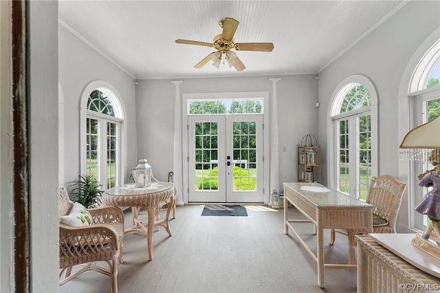 doorway to outside featuring light colored carpet, french doors, crown molding, and a ceiling fan