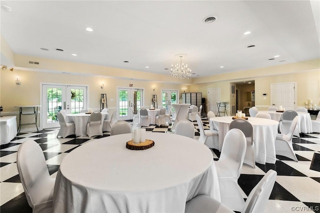 dining area with a notable chandelier, recessed lighting, french doors, and visible vents