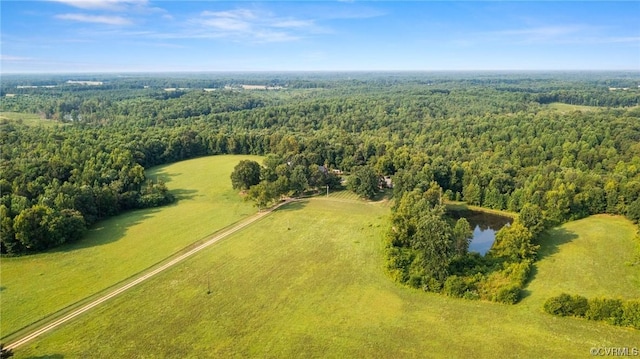 drone / aerial view with a wooded view