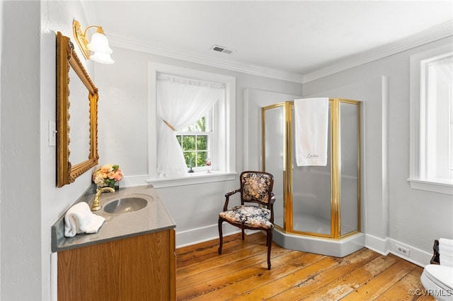 bathroom with visible vents, a shower stall, hardwood / wood-style floors, and crown molding