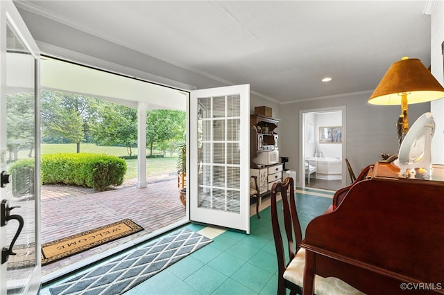 doorway featuring tile patterned flooring, crown molding, plenty of natural light, and recessed lighting