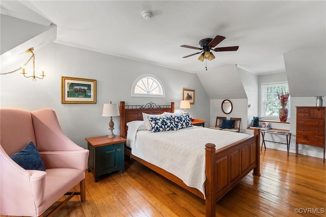 bedroom with multiple windows, light wood-style floors, and lofted ceiling