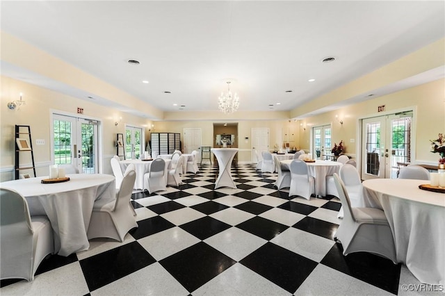 dining room with a healthy amount of sunlight, french doors, and an inviting chandelier