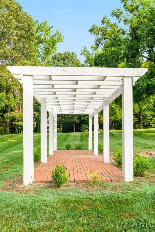 surrounding community featuring a lawn and a pergola