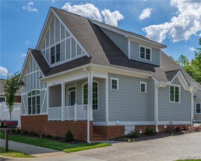 view of side of home with covered porch