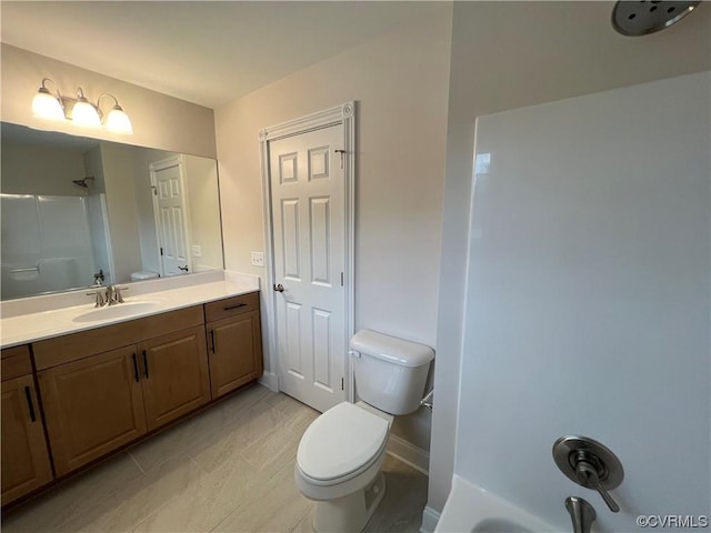 bathroom featuring vanity, walk in shower, toilet, and baseboards