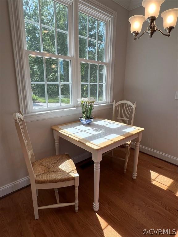 unfurnished dining area with a healthy amount of sunlight, an inviting chandelier, and light wood-style floors