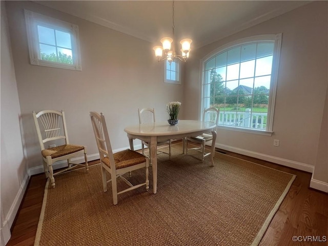 dining room with baseboards, dark wood-type flooring, and an inviting chandelier