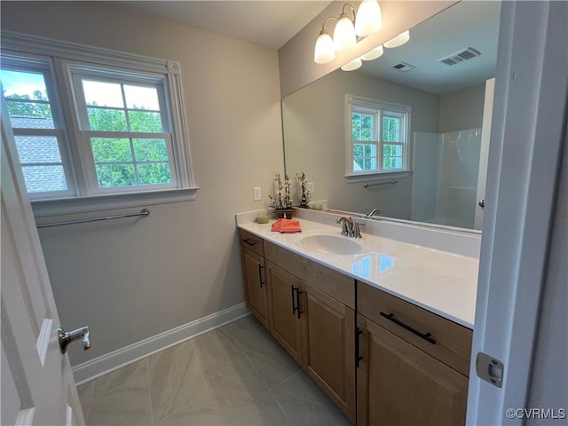 full bathroom with marble finish floor, vanity, visible vents, and baseboards