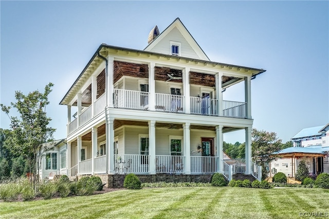 view of front of property with a front lawn, a balcony, and covered porch