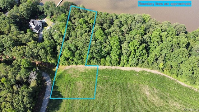 birds eye view of property with a wooded view