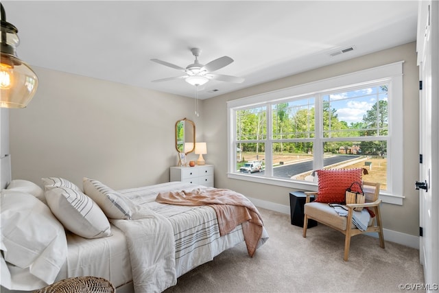 bedroom with light carpet and ceiling fan