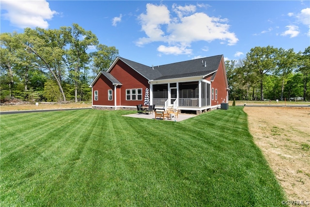 back of house featuring central AC unit and a yard