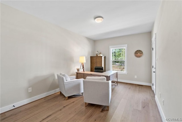 office area featuring light wood-style flooring and baseboards