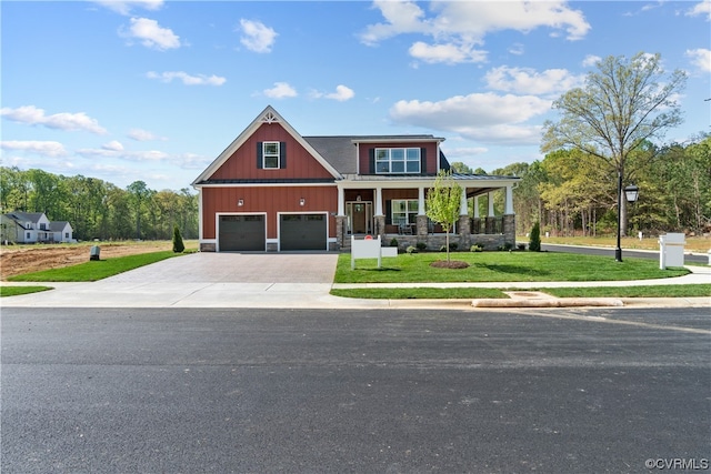 craftsman-style home featuring a porch, a front lawn, and a garage