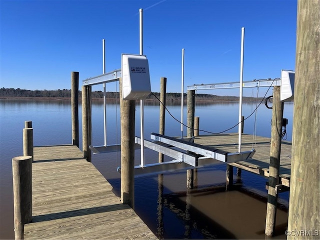 dock area with a water view and boat lift