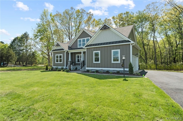 craftsman-style home featuring a front lawn, a porch, and a garage