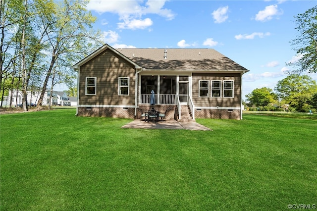 back of property with a yard and a patio area