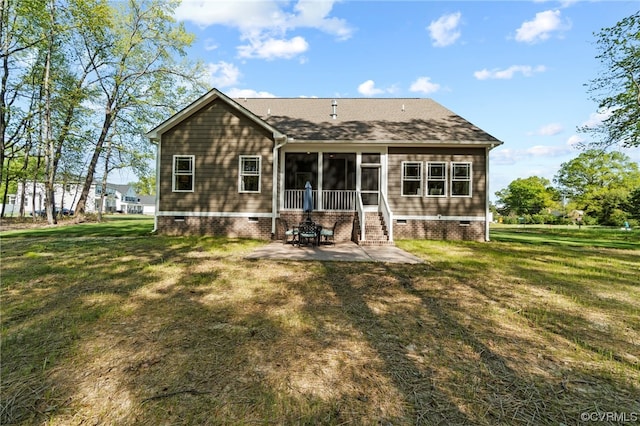 back of property featuring a lawn and a patio area