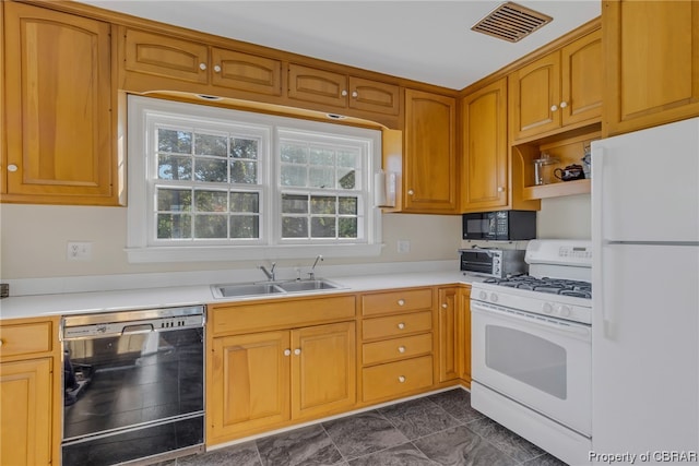 kitchen featuring dark tile flooring, black appliances, and sink