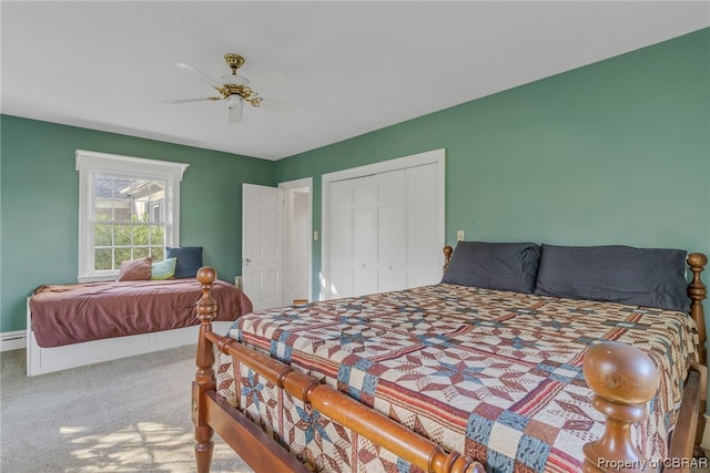 bedroom with ceiling fan, light colored carpet, and a closet