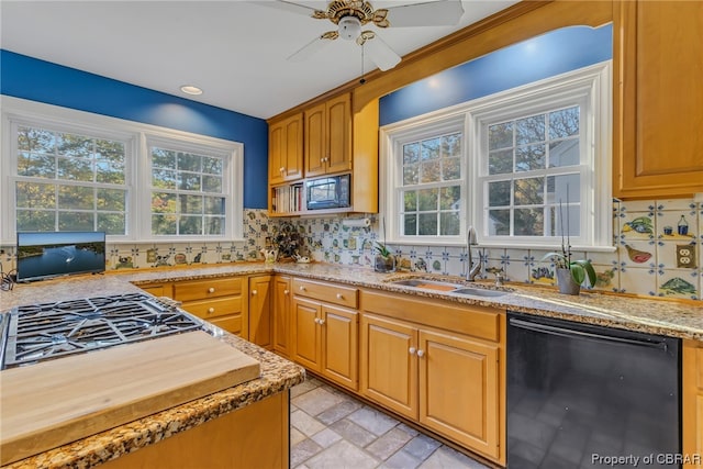 kitchen with light tile flooring, ceiling fan, black appliances, backsplash, and sink