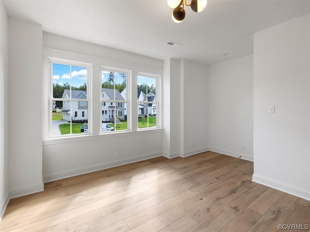 spare room featuring light hardwood / wood-style flooring