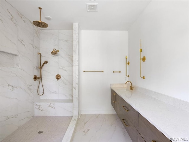 bathroom featuring a tile shower and vanity