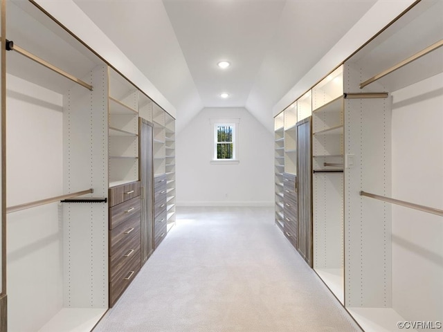 spacious closet with light carpet and lofted ceiling