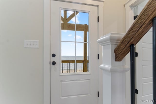 doorway to outside featuring a water view