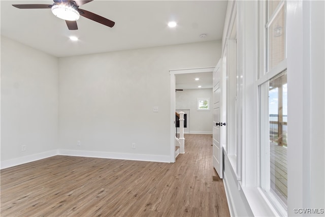 unfurnished room with ceiling fan and light hardwood / wood-style flooring