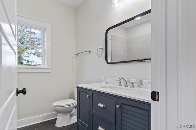 bathroom with hardwood / wood-style flooring, vanity, and toilet