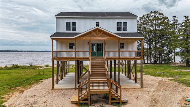 view of front of home with a water view, a front yard, and a porch