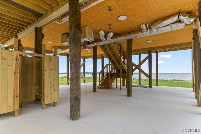 exterior space featuring concrete flooring and a water view