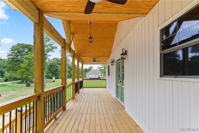 wooden terrace featuring ceiling fan