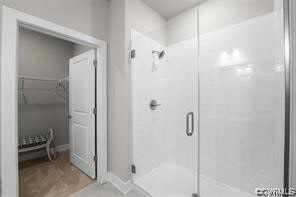 bathroom with tile floors and a shower with shower door