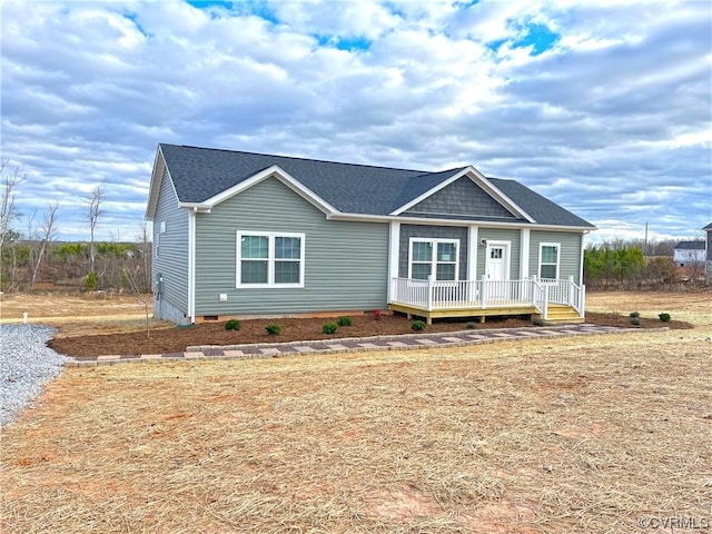 view of front of house featuring covered porch and a shingled roof