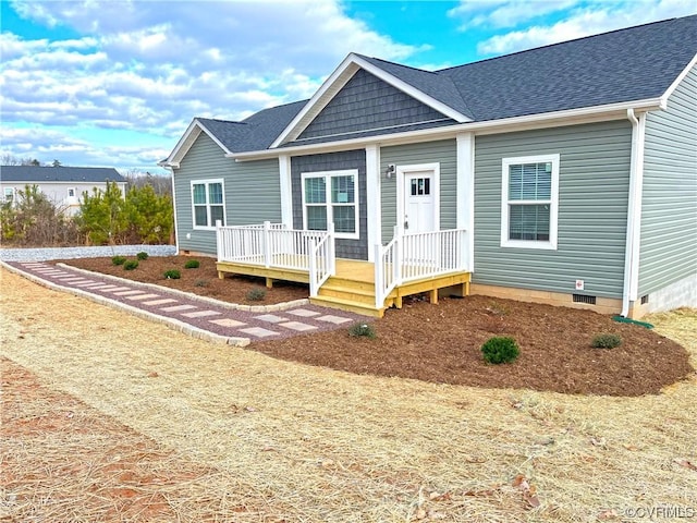 view of front of property with crawl space, a deck, and a shingled roof