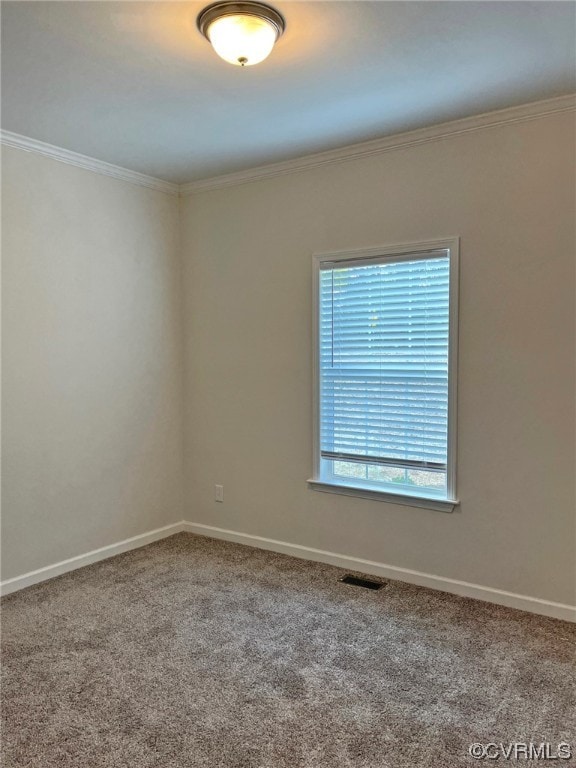 unfurnished room with visible vents, baseboards, carpet, and ornamental molding