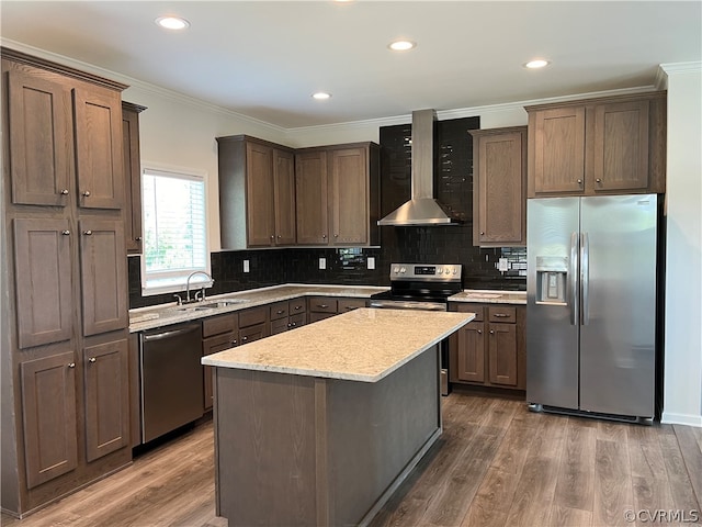 kitchen featuring a sink, dark wood-type flooring, wall chimney exhaust hood, and stainless steel appliances