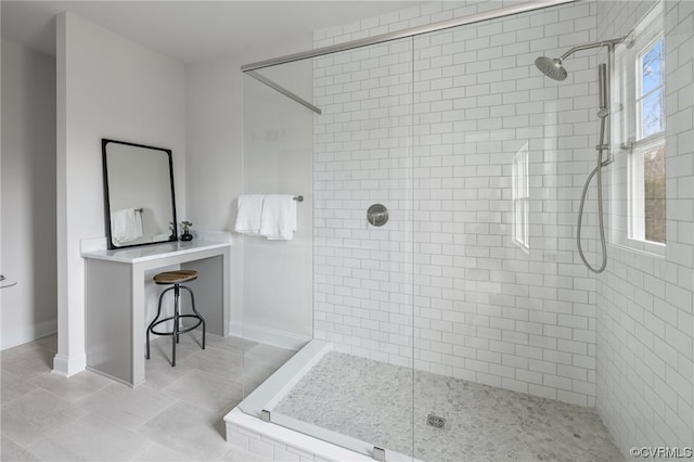 bathroom featuring tile floors and a tile shower