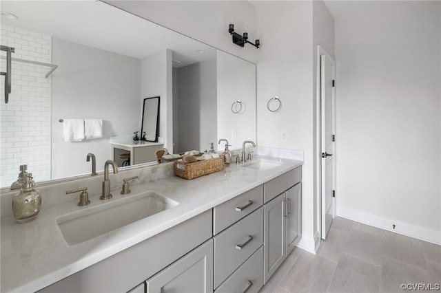 bathroom featuring double sink, tile floors, and vanity with extensive cabinet space