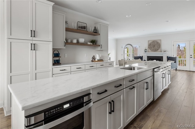 kitchen with dark hardwood / wood-style flooring, sink, appliances with stainless steel finishes, and plenty of natural light