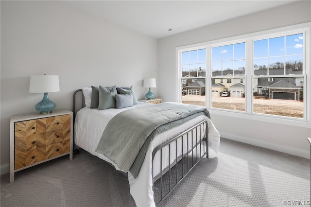 carpeted bedroom featuring multiple windows