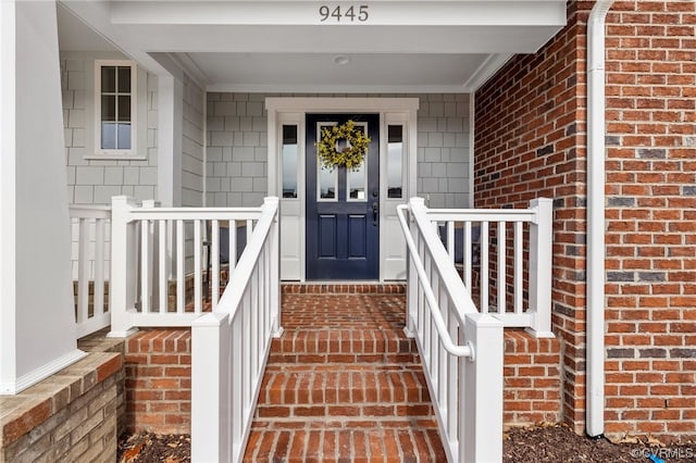 view of exterior entry featuring covered porch