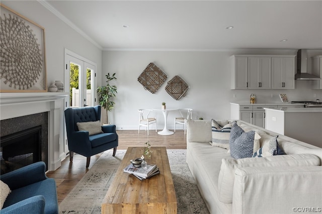 living room with hardwood / wood-style floors, french doors, and ornamental molding