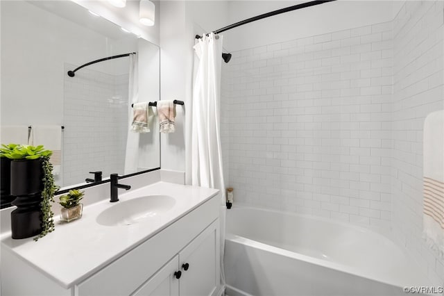 bathroom with shower / bathtub combination with curtain and vanity with extensive cabinet space