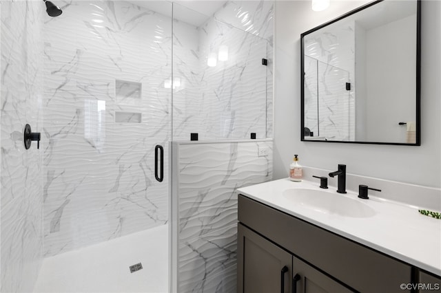 bathroom with large vanity and a shower with shower door