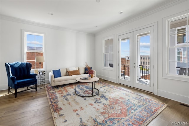 living room featuring a healthy amount of sunlight, hardwood / wood-style floors, and french doors